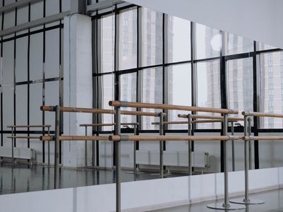 Empty bright training room with large windows and mirrors