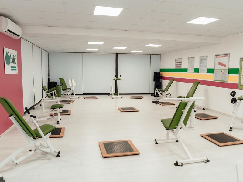 Modern fitness equipment arranged in a clean minimalist gym